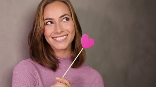 Smiling Woman Holding Pink Heart Smiling