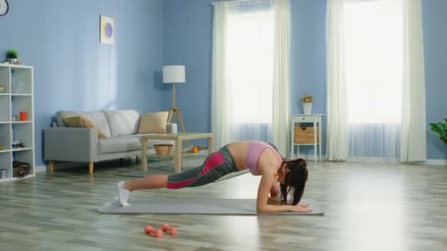 Woman Exercising in a Brightly Lit Living Room