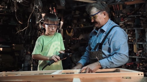 Boy and Man Working Together on Woodworking Project