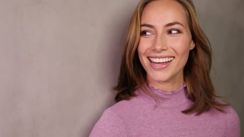 Smiling Woman in Purple Sweater Looking to Side