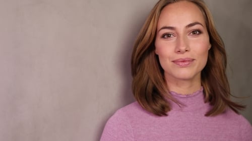 Smiling Woman in Pink Sweater Posing Indoors
