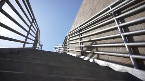 Man Running Up Concrete Staircase Outdoors
