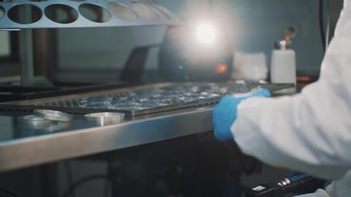 Optician Checking Lens with Laser Device at Manufacture Metal Desk