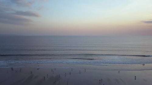 Beach Scene at Sunset with Silhouetted People