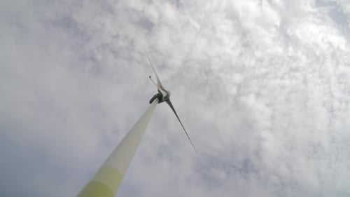 Wind Turbine over Stormy Cloudy Sky Using Renewable Energy to Generate Electrical Power