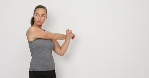 Woman Stretching Arms in Fitness Attire