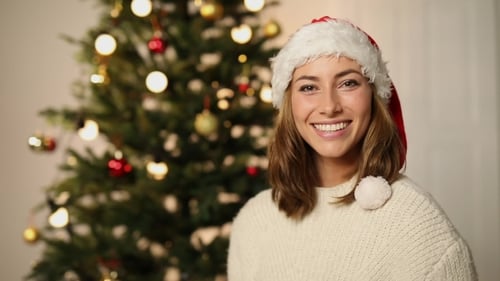 Woman in Santa Hat Holding Christmas Present