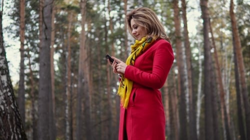 Woman Takes Selfie in Autumn Forest