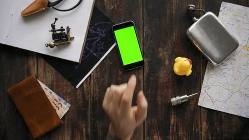 Phone With Green Screen on Wooden Table