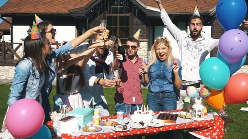 Group of Cheerful Friends Having a Party in the City Throwing Confetti and Drinking Champagne
