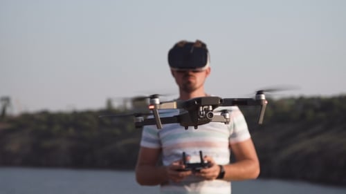 Man Operating Drone with Virtual Reality Headset
