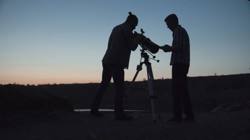 People Observing Stars with Telescope at Sunrise