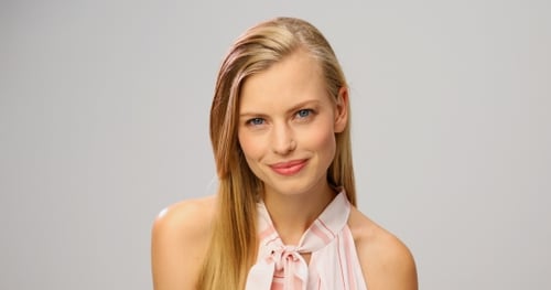 Attractive Young Woman Smiling in Studio Close Up