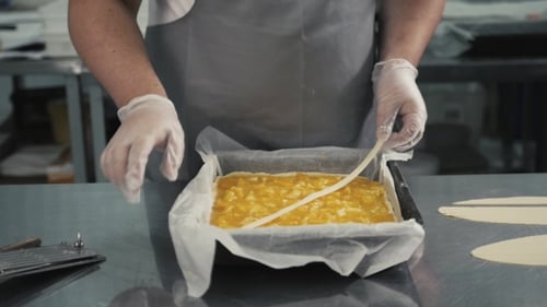 Man Prepares a Fruits Orange Lemon Pie on a Kitchen Table, Final Decoration in Gloves, Restaurant