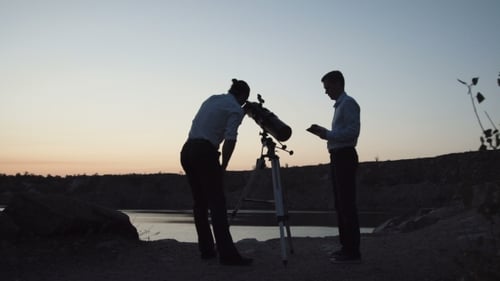 Men Exploring Space with Telescope