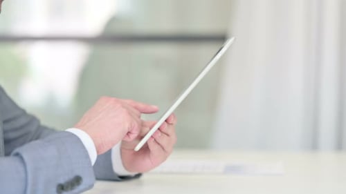 Close Up of Businessman Using Digital Tablet