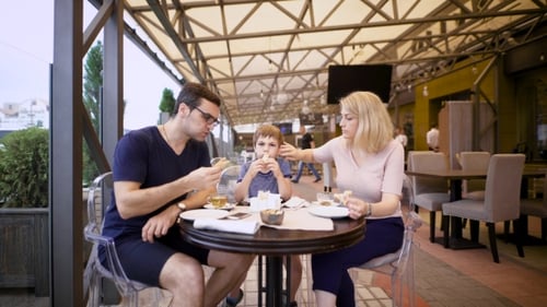 Image of a Happy Family and Their Son at the Cafe. Loving Couple with Child Are Spending Time