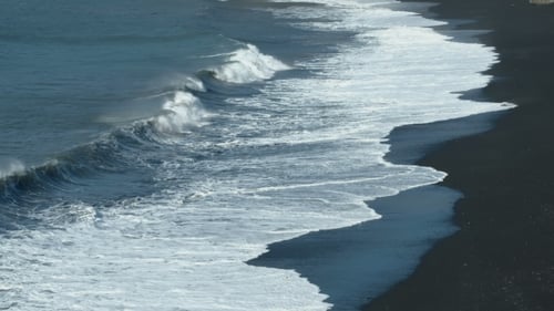 Black Sand Volcanic Beach with White Sea Foam in Azores Islands.