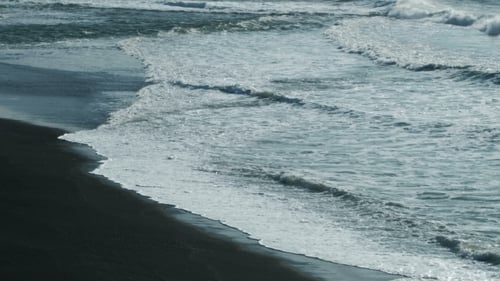 Black Sand Volcanic Beach with White Sea Foam in Azores Islands
