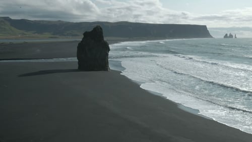 Famous Reynisdrangar Rock Formations at Black Reynisfjara Beach. Coast of the Atlantic Ocean