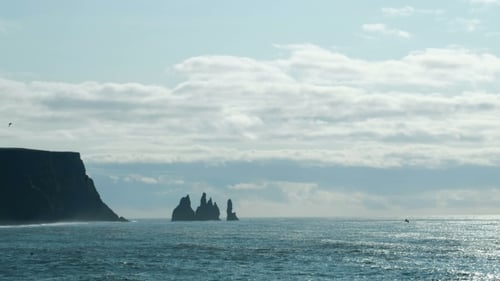 Famous Reynisdrangar Rock Formations at Black Reynisfjara Beach. Coast of the Atlantic Ocean