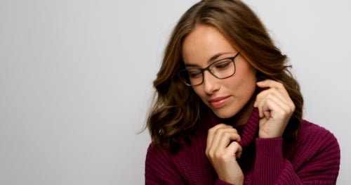 Pretty Brunette Woman in Glasses and Purple Sweater Posing