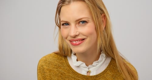 Blonde Woman Smiling Cheerfully at Camera