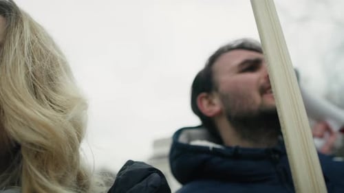 Close up of group of young caucasian people manifesting against conflict in Ukraine. Shot with RED h