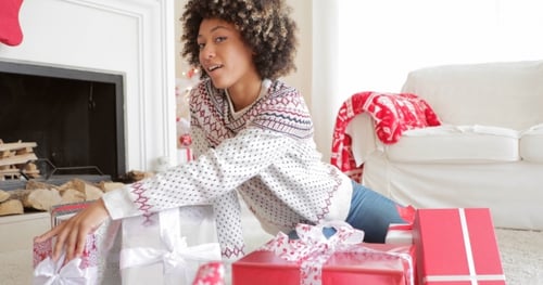 Happy Woman Presents Christmas Gifts at Home