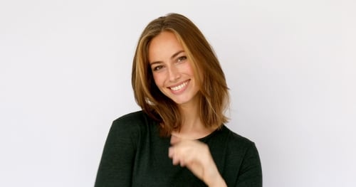 Smiling Woman Posing in Front of White Background