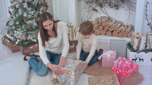 Woman and Child Wrapping Christmas Presents Together