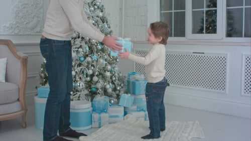 Boy Receives Christmas Gift from Father
