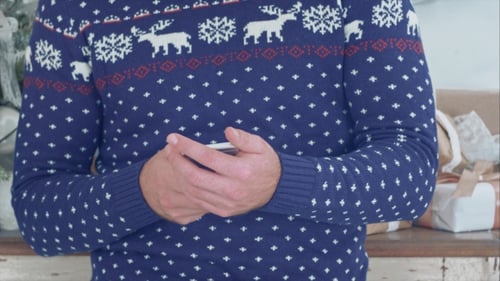 Man Using Cellphone Wearing Festive Christmas Sweater