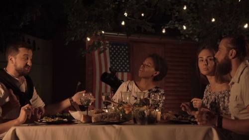 Friends Celebrating at Outdoor Dinner Party at Night