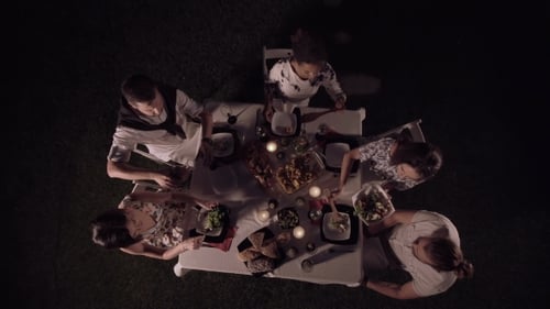 Friends Enjoying Candlelit Dinner Under the Stars
