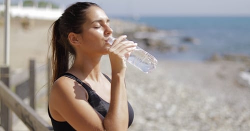 Woman Refreshing During Workout