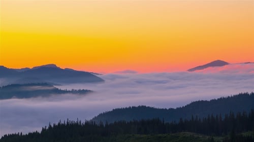 Beautiful Golden Sunrise over Misty Mountain Ridges