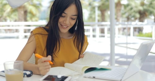 Woman Studying with Laptop Outdoors