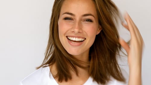 Smiling Woman Posing in Front of White Background