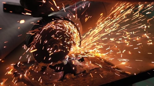 Cutting Metal with Disc Grinder with Bright Sparks
