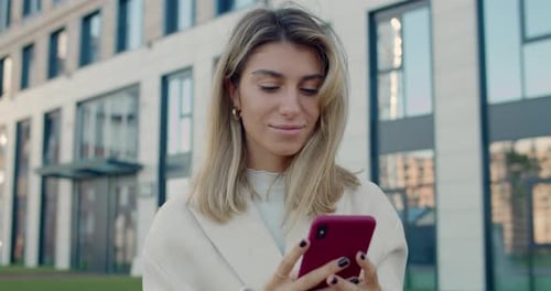Crop View of Happy Female Person Using Smartphone While Standing at City Street. Stylish Young Woman