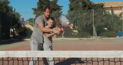 Father and Son Playing Tennis on Court, Tennis Training