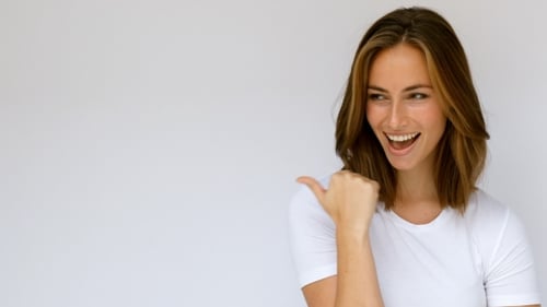 Attractive Woman Smiles and Gestures in Studio