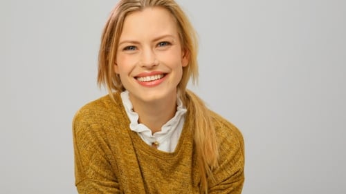 Smiling Woman Wearing a Yellow Sweater
