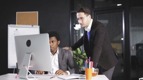 Two Men in the Office Discussing the Project in Front of the Computer