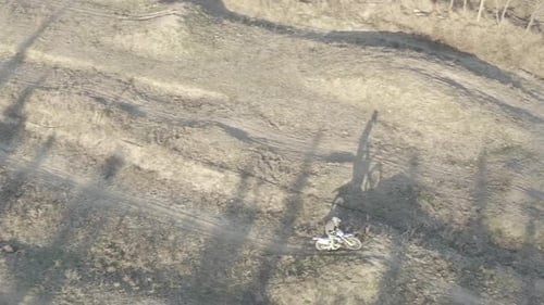 Aerial view of a motocross rider on a dirt track