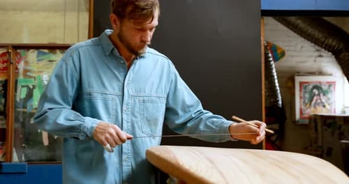 Man making surfboard 4k