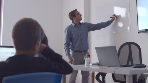 Male School Teacher Drawing on Whiteboard