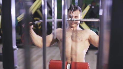 Brutal Strong Athletic Men Pumping Up Muscles and Train in Gym
