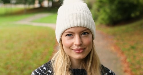 Smiling Woman in Beanie in Autumn Park
